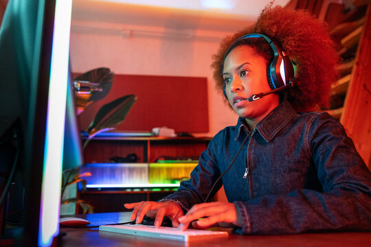 Focused female gamer immersed in the digital world