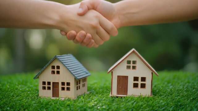 Small living eco house with people shaking hands