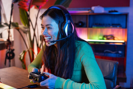 Smiling female Gamer Enjoying multiplayer game