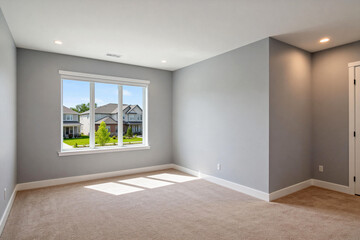 Obraz premium Spacious Empty Bedroom with Large Window and Carpets