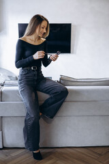 Young woman applying make up using brushes