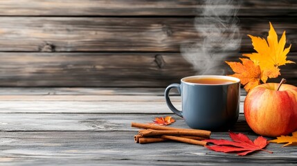 Cozy Autumn Scene with Hot Tea, Apple, Cinnamon, and Fall Leaves on Rustic Wood