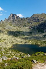 Mountain landscape. A beautiful blue lake among mountain peaks and cliffs. Lake Karovoe. Ergaki Nature Park