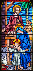 Stained glass of Holy family in the workshop of Joseph the carpenter.