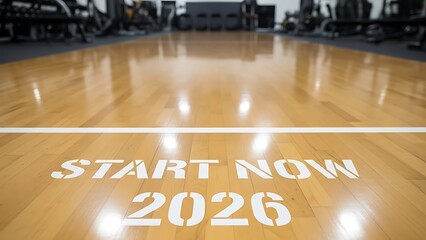 A sleek sports court with a motivational message 'Start Now 2026' on the polished wooden floor, viewed from a low angle.