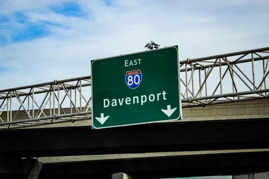 Midwest travel and transportation background. A guide sign and bridge on Interstate 80 (I-80) East near Davenport, Iowa
