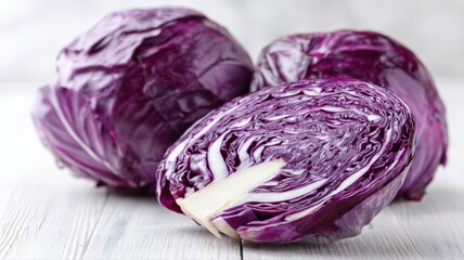 Obraz premium Fresh Red Cabbage Still Life: Vibrant Colors and Textures of Healthy Vegetables on White Wood