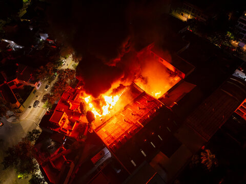 A fire is burning in a building, with smoke and flames visible