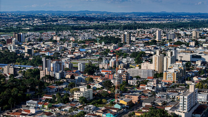 Drone footage of the city of S&atilde;o Jos&eacute; dos Pinhais, located in the dynamic metropolitan region of Curitiba, on a day with a blue sky and some clouds, showing the central area.