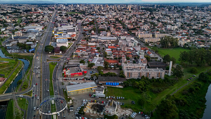 Drone footage of the city of S&atilde;o Jos&eacute; dos Pinhais, located in the dynamic metropolitan region of Curitiba, on a day with a blue sky and some clouds, showing the central area.