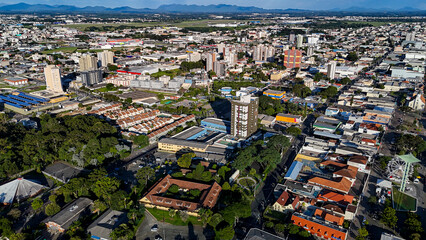 Drone footage of the city of S&atilde;o Jos&eacute; dos Pinhais, located in the dynamic metropolitan region of Curitiba, on a day with a blue sky and some clouds, showing the central area.