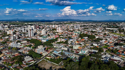 Drone footage of the city of S&atilde;o Jos&eacute; dos Pinhais, located in the dynamic metropolitan region of Curitiba, on a day with a blue sky and some clouds, showing the central area.