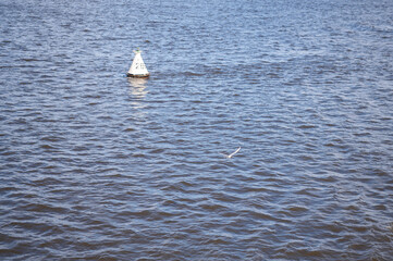 White triangular buoy on the river
