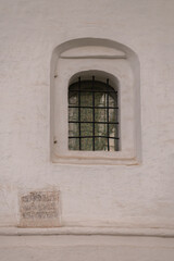 Fototapeta premium An arched window with a lattice in an Orthodox church