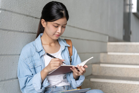 beautiful Asian woman student. Smile girl happy study. read book in college campus. young female on international Asia University. Education, study, school, learning, exam, continue education