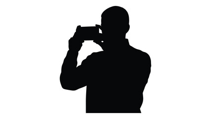 Silhouette of a man holding up a camera to take a photograph