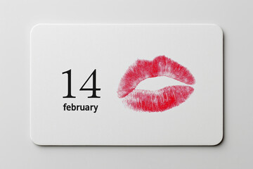 Calendar page showing February 14 highlighted with a red lipstick kiss mark, symbolizing Valentine&rsquo;s Day, love, romance and romantic celebration concept.