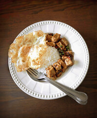 Steamed rice with stir-fried pork sausage, chili, and garlic, and a fried egg.