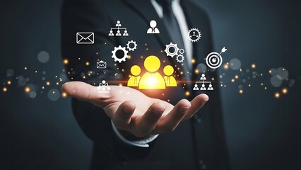 Human resources and team management concept showing a hand holding glowing people icons and business symbols.
