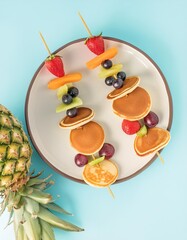 Mini pancakes and fruit skewers for healthy breakfast