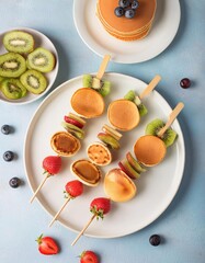 Mini pancakes with fresh fruit skewers for breakfast