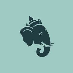 Stylized elephant head with ornate headdress and tusks.