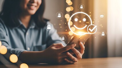 Woman using smartphone to provide positive feedback with glowing smiley face icon for customer satisfaction and service rating