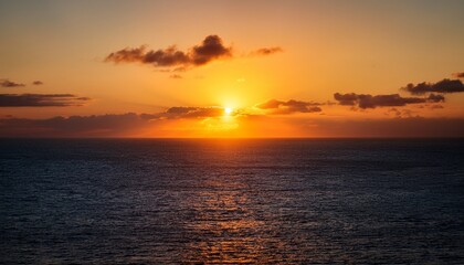Fototapeta premium The Setting Sun Peaks Over The Ocean Before Dipping Below The Horizon
