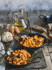 Obraz premium Vertical photo of two plates of migas, a traditional Spanish dish