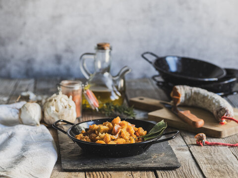 Horizontal photo of a traditional Spanish dish of migas in a rustic scene with copy space