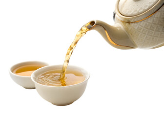 Traditional tea being poured from a white teapot into a ceramic tea cup