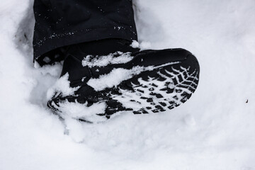 a children&rsquo;s shoe covered with snow