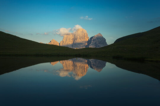 Mount Ra Gusela at Passo Giau with water reflection, Dolomites, Italy. Beautiful alpine landscape at sunset.