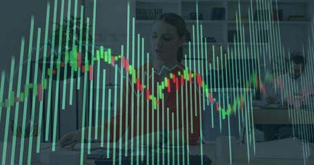 Working woman in red blouse typing at desk in office, candlestick chart overlaying monitors