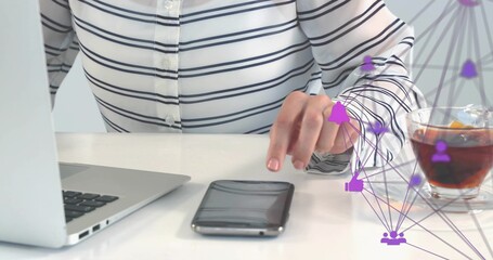 Reaching woman in striped top tapping phone at white desk, silver laptop, glass cup, purple overlay