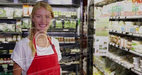 Smiling grocery employee standing in fridge aisle, red apron, glass HUD reflection, copy space