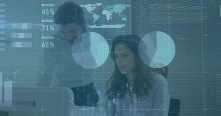 Reviewing seated woman wearing light blouse studying data at office desk, with monitor percentages