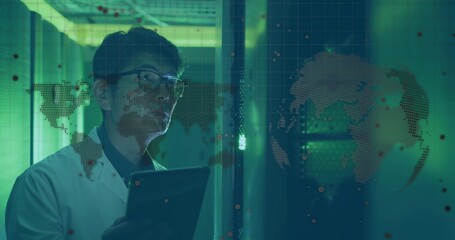 Monitoring man in lab coat, glasses holding tablet in corridor, viewing glass map with red points