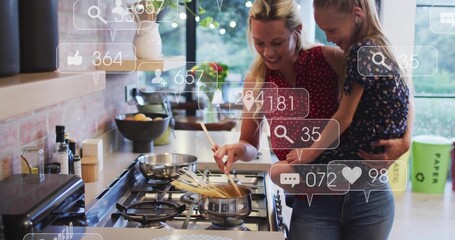 Stirring mom holding child in home kitchen on gas cooktop, wearing red blouse with social icons