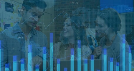 Gathering 3 staff in blazers at office leaning over open laptop, viewing charts overlay and headset