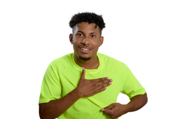 A smiling young man in a neon green t-shirt gestures, beating his chest, against 