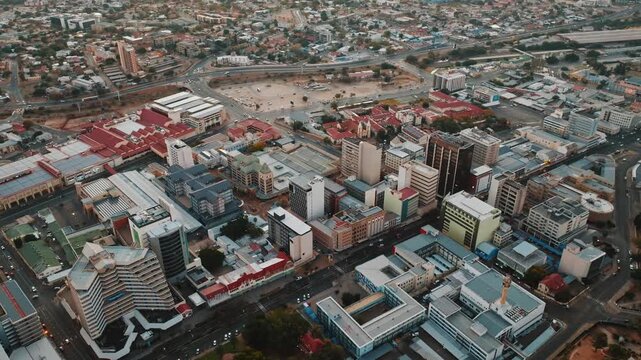 Stunning aerial drone footage of Windhoek, the capital city of Namibia. Modern cityscape with urban streets, buildings, and infrastructure captured from above