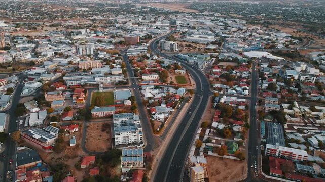 Stunning aerial drone footage of Windhoek, the capital city of Namibia. Modern cityscape with urban streets, buildings, and infrastructure captured from above