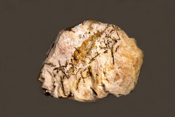 Chalcopyrite with yellow flecks on a dark background. Gems, mineralogy, jewelry.