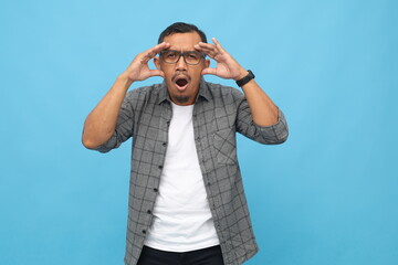 Asian man with stunned expression looking at something, shocked hearing news, surprised hand...