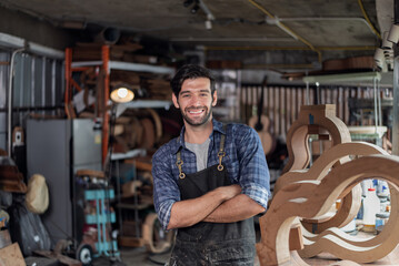 Portrait of guitar luthier small business owner in workroom.