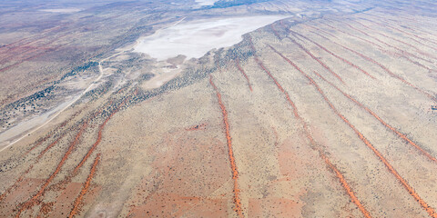 dry pan and lines of Kalahari parallel red dunes, near Auob Camp, Namibia
