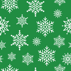 Seamless winter pattern with white snowflakes on a festive green background