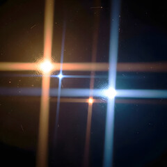 Abstract Light Grid with Blue and Golden Lens Flares on Dark Background.
