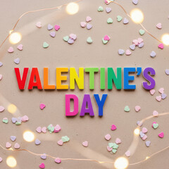 Colorful Alphabet Blocks Spelling Valentine Day Message with Heart Confetti and Fairy Lights